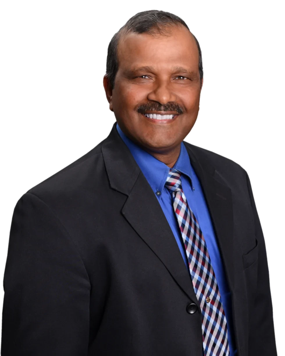 Kris Persaud, Realtor, in a black suit, blue shirt and checked tie