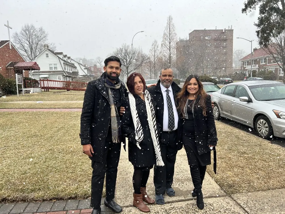 Kris Persaud with family on a snowy city street