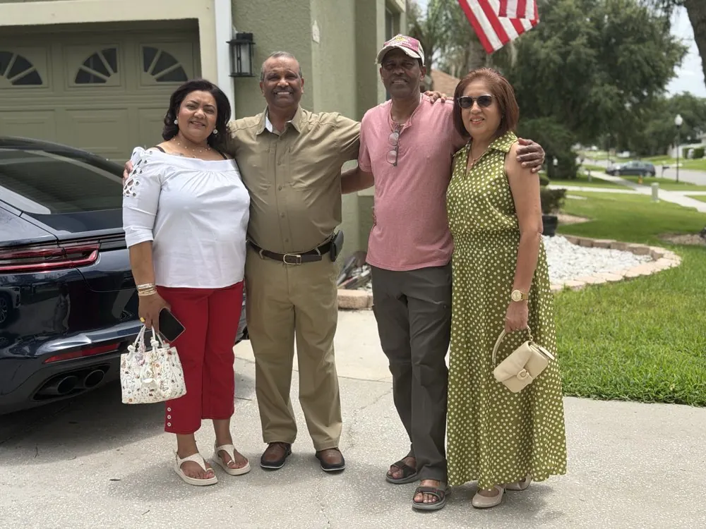 Kris Persaud with family outside a home