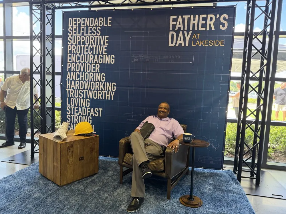 Kris Persaud seated at a Father's Day event at church