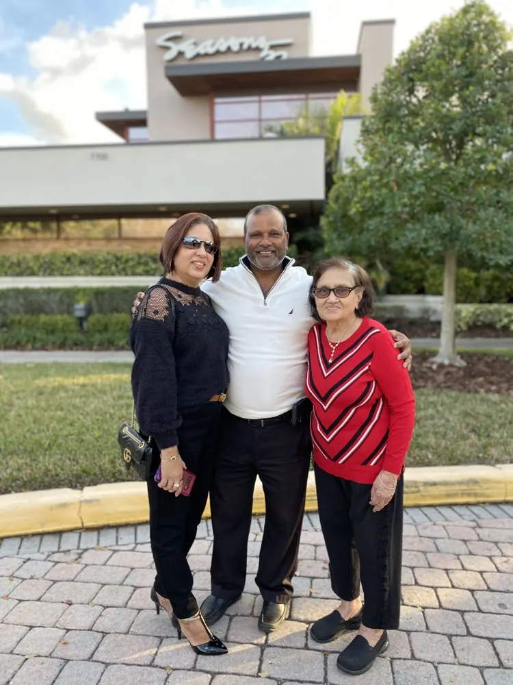 Kris Persaud with family outside a restaurant